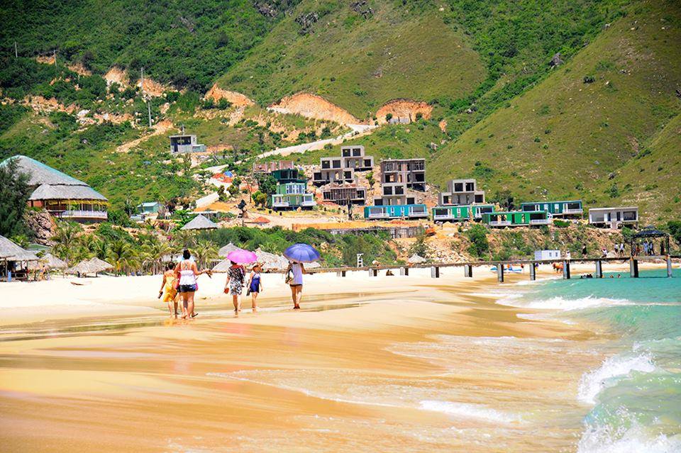 Visitors enjoying the white sand and turquoise water at Ky Co Beach